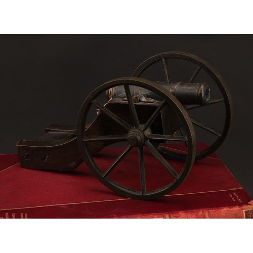 2218 - A bronze library model signalling cannon, 13cm barrel, the oak carriage with bronze wheels, 28cm lon... 