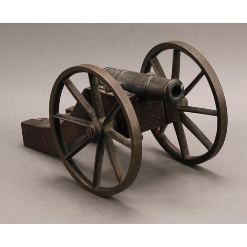 2218 - A bronze library model signalling cannon, 13cm barrel, the oak carriage with bronze wheels, 28cm lon... 