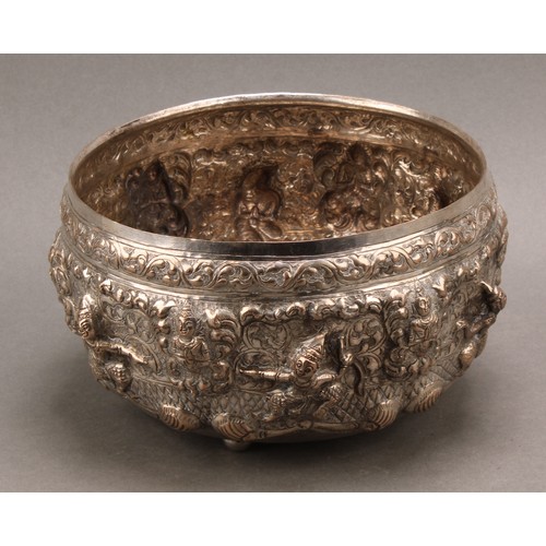 719 - A Burmese silver bowl, repousse chased with deities and figures on a ground of leafy scrolls, 17cm d... 