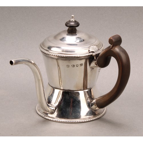 1017 - An early George III silver argyle, domed cover with shell shaped hinge, scroll-capped fruitwood hand... 