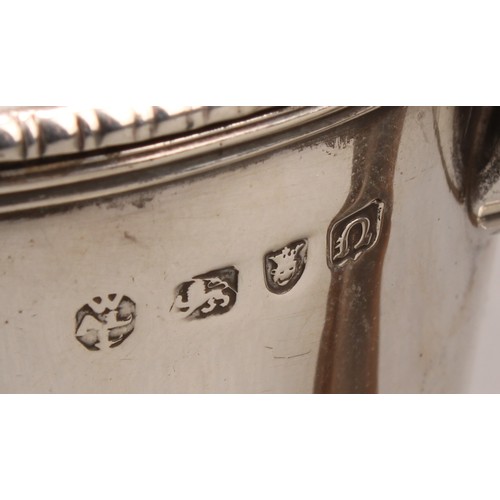 1017 - An early George III silver argyle, domed cover with shell shaped hinge, scroll-capped fruitwood hand... 