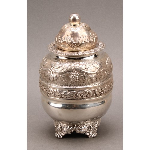 801 - A George IV silver ovoid tea caddy, chased with bands of fruiting vine, domed cover, paw feet, 13cm ... 