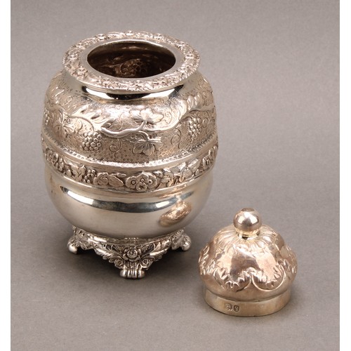 801 - A George IV silver ovoid tea caddy, chased with bands of fruiting vine, domed cover, paw feet, 13cm ... 