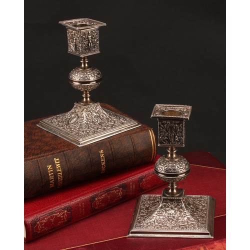 893 - A pair of Victorian Renaissance Revival silver square table candlesticks, chased with putti, 'Green ... 