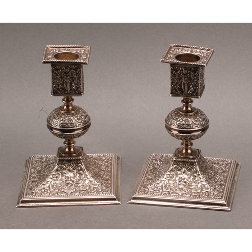 893 - A pair of Victorian Renaissance Revival silver square table candlesticks, chased with putti, 'Green ... 