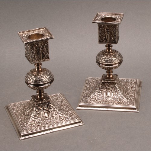 893 - A pair of Victorian Renaissance Revival silver square table candlesticks, chased with putti, 'Green ... 