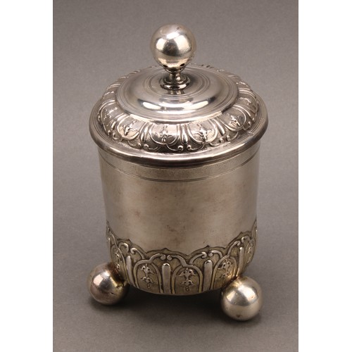 981 - An 18th century German silver cup and cover, chased with bands of leaves and ovolo strapwork, ball f... 