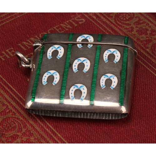 1027 - An Edwardian silver and enamel rounded rectangular vesta case, decorated in polychrome with horse sh... 