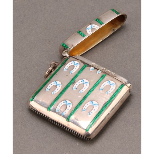 1027 - An Edwardian silver and enamel rounded rectangular vesta case, decorated in polychrome with horse sh... 