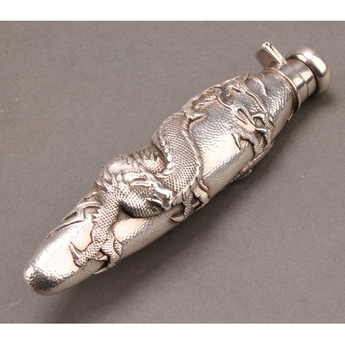 836 - A Japanese silver scent bottle, chased with a ferocious dragon on a textured ground, hinged domed co... 