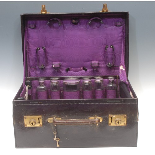 2201 - A George V silver fitted purple morocco leather travelling case, hinged cover enclosing bottles, jar... 