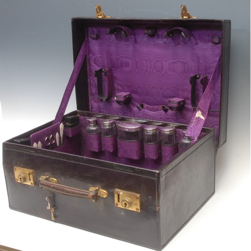 2201 - A George V silver fitted purple morocco leather travelling case, hinged cover enclosing bottles, jar... 