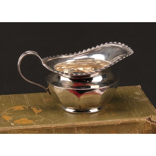 1030 - An Edwardian silver cream jug, gadrooned border, 13cm long, James Dixon & Son Sheffield 1909, 162g