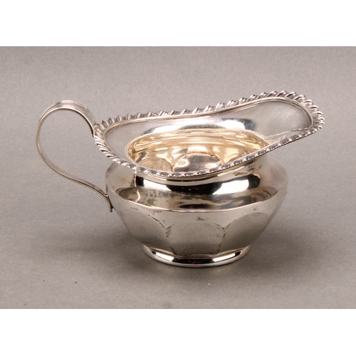 1030 - An Edwardian silver cream jug, gadrooned border, 13cm long, James Dixon & Son Sheffield 1909, 162g