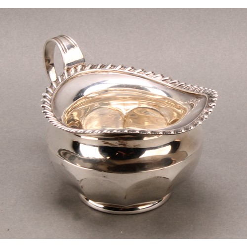 1030 - An Edwardian silver cream jug, gadrooned border, 13cm long, James Dixon & Son Sheffield 1909, 162g