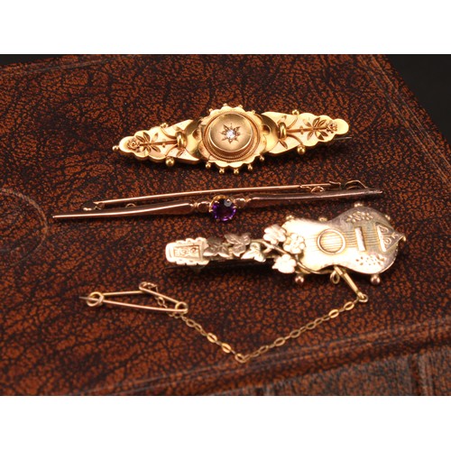 1237 - A Victorian diamond accented 15ct gold brooch, 3.2g gross;  a 9ct gold floral guitar brooch, 3.3g;  ... 