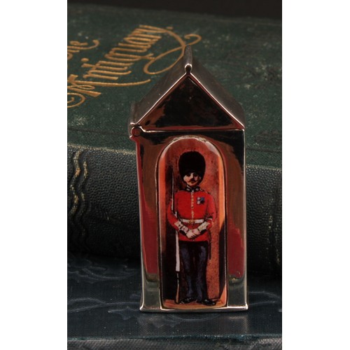 915 - A silver and enamel novelty vesta case, decorated with a guardsman in a sentry box, 6cm long, marked... 