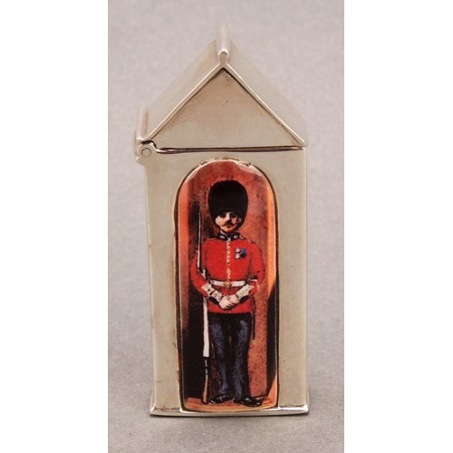 915 - A silver and enamel novelty vesta case, decorated with a guardsman in a sentry box, 6cm long, marked... 