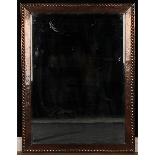 2572 - An Arts & Crafts period sheet copper mounted chimney glass, bevelled mirror plate, 121cm x 92cm, c.1... 