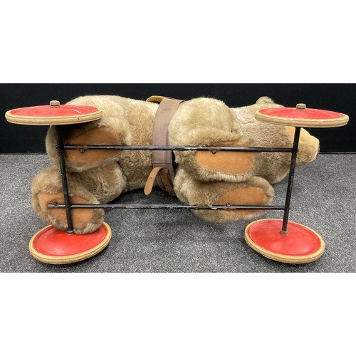 6527 - A mid 20th century Ride on Bear, possibly steiff, glass eyes, shaped snout, wood wool stuffing, meta... 