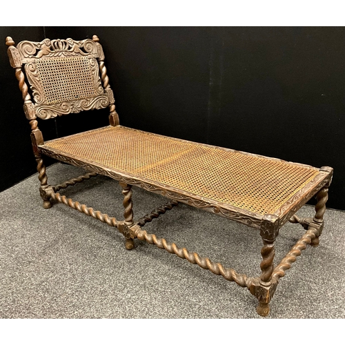 1889A - ***LOT WITHDRAWN***A Carolean oak day bed, shaped cresting rail pierced and carved with putti suppor... 