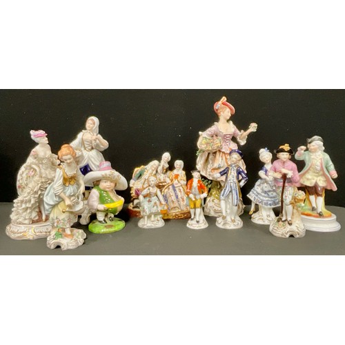 132 - A pair of Sitzendorf porcelain figures, of gardeners, he stands holding a spade, she with a watering... 