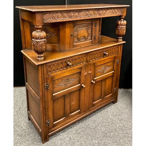 23 - A 17th century style carved oak court cupboard, 136.5cm high x 122cm wide x 47cm deep.