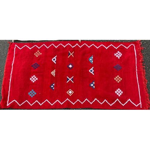 36 - A Navajo Yei wool rug, 127cm x 73cm;  a Moroccan kilim style rug, hand-knotted in rich red with trad... 