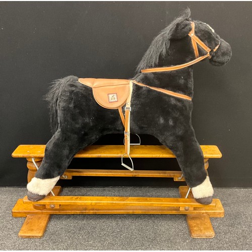 57 - A mamas and papas rocking horse, black plush body, curly black plume, wooden base with metal fitting... 