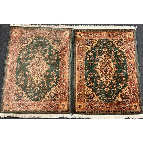Two Middle Eastern style woollen rugs, knotted in tones of deep green ...