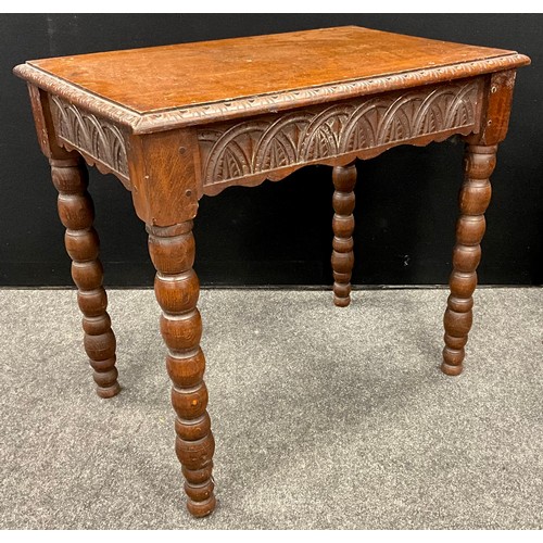 105 - A carved oak side table, early 20th century, Gothic style carved frieze, bobbin turned legs, 70cm hi... 