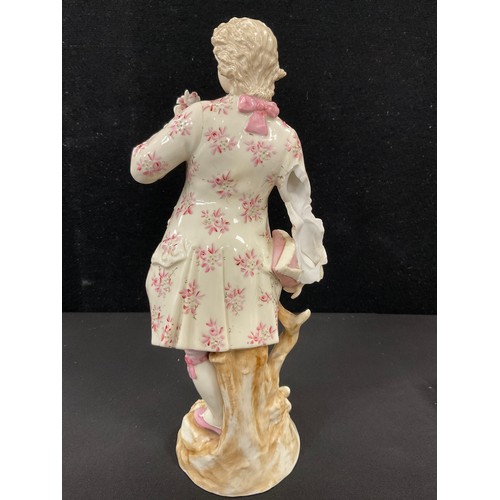 129 - A pair of 19th century continental porcelain figures, Dandy and companion, the man painted with pink... 