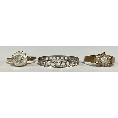 642 - A white metal diamond eternity ring, with four remaining round brilliant cut diamonds, unmarked whit... 