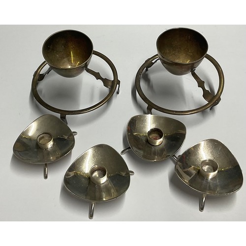 53 - A set of four Carl Cohr for Atla silver plated candle holders, modernist triangular bowls, tripod fe... 