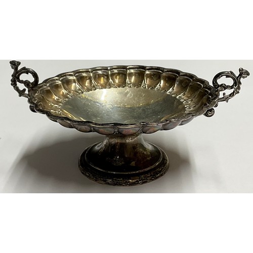 57 - A Victorian silver pedestal bonbon dish, embossed with leafy collar, scrolling caryatid handles, Tho... 