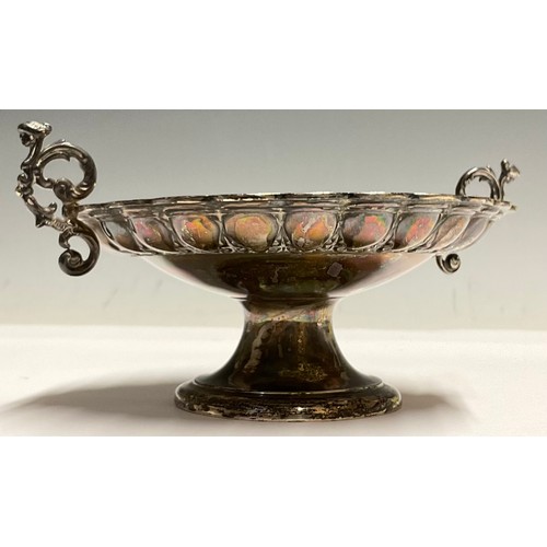 57 - A Victorian silver pedestal bonbon dish, embossed with leafy collar, scrolling caryatid handles, Tho... 