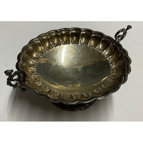 57 - A Victorian silver pedestal bonbon dish, embossed with leafy collar, scrolling caryatid handles, Tho... 