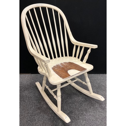 330 - A spindle-back rocking chair, painted white, 105cm high x 59cm wide.