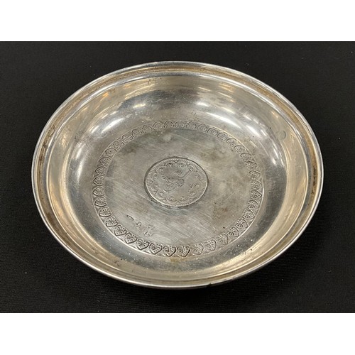 340 - An Iranian silver dish, 10cm diameter.