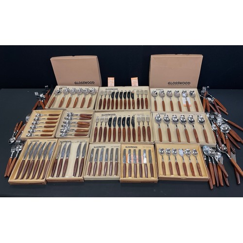 189 - An extensive Glosswood table service comprising 6 steak forks, 6 steak knives, 12 table forks, 12 ta... 