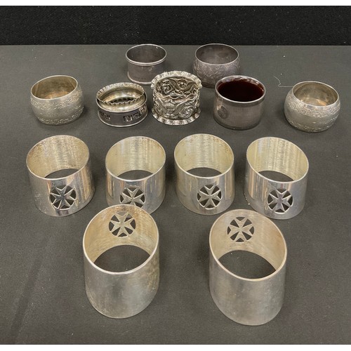 344 - A pair of late Victorian silver napkin rings, London 1897, others assorted dates, 145g gross, anothe... 