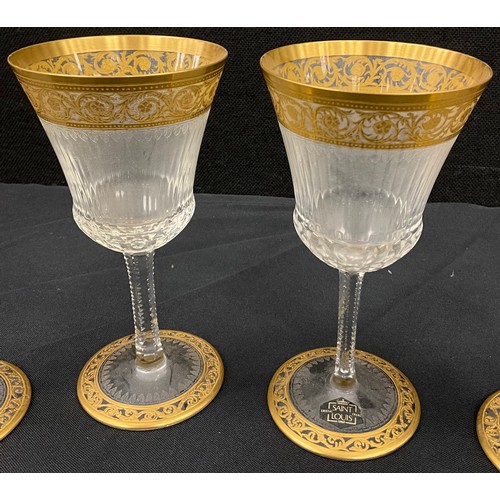 6 - A set of five Saint Louis crystal wine glasses, fluted shape with gilt detail, 16cm high, (5).