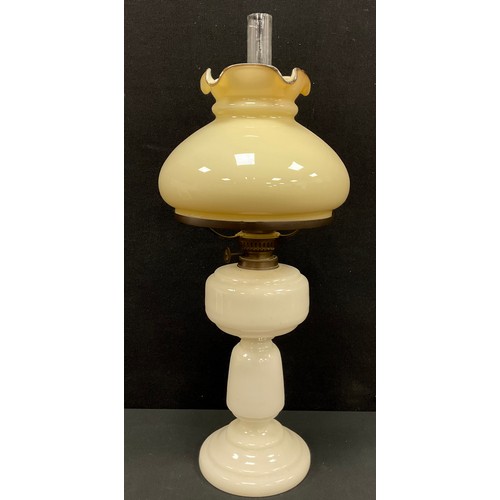 4 - A late 19th century Victorian Milk Glass oil lamp, frilled edged shade, 55cm high.