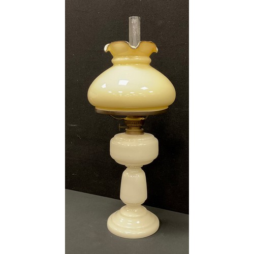 4 - A late 19th century Victorian Milk Glass oil lamp, frilled edged shade, 55cm high.