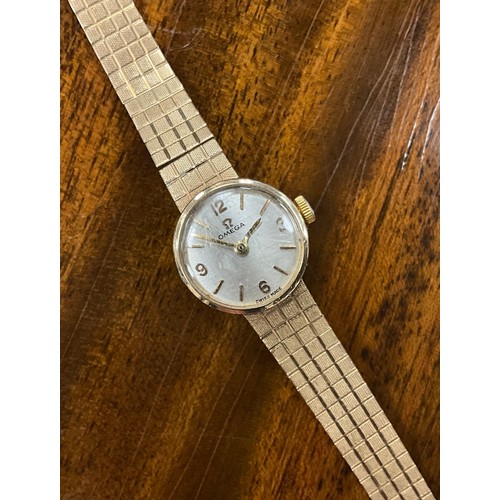 1037 - Omega - a 1960s 9ct gold lady's cocktail wristwatch, silver dial, quartered Arabic numerals and bloc... 