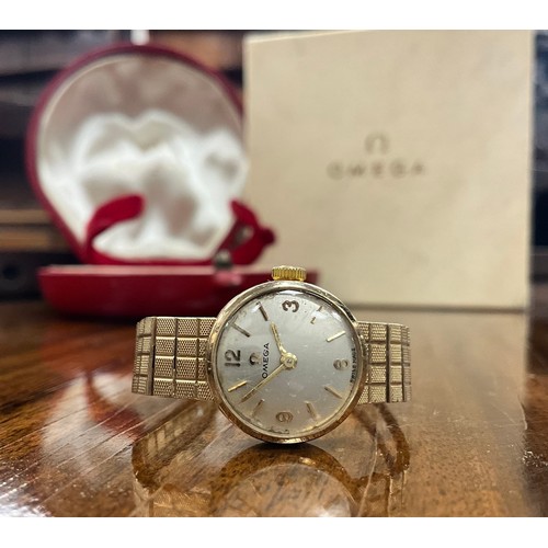 1037 - Omega - a 1960s 9ct gold lady's cocktail wristwatch, silver dial, quartered Arabic numerals and bloc... 