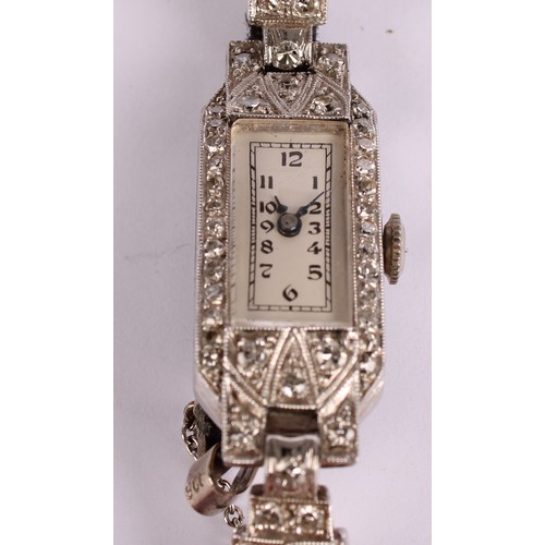 1047 - An early 20th century platinum and diamond cocktail watch, canted rectangular platinum case and stra... 