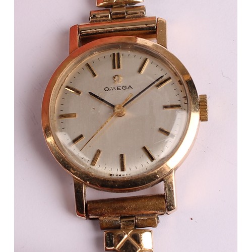 1057 - Omega - a 1960s lady's 9ct gold cased wristwatch, 21mm diameter case, silvered dial, block baton mar... 