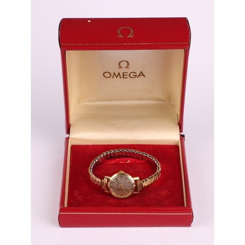 1057 - Omega - a 1960s lady's 9ct gold cased wristwatch, 21mm diameter case, silvered dial, block baton mar... 