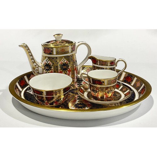 19 - Royal Crown Derby - an 1128 old Imari miniature bachelors tea set on oval tray, comprising teapot, m... 